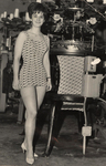 Woman modeling swimsuit, with knitting machine, 1960s